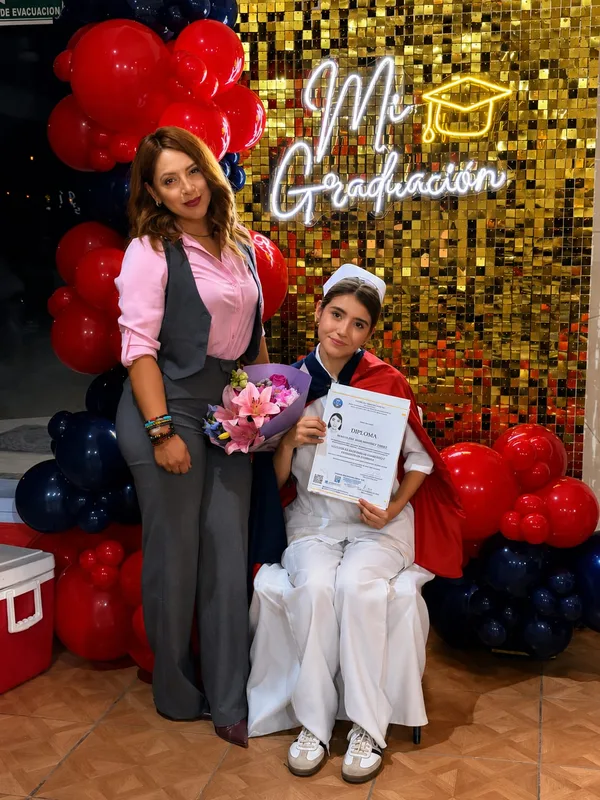 Graduada con su diploma y su madrina